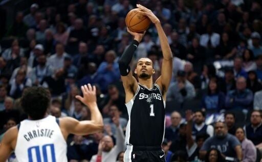 San Antonio star Victor Wembanyama shoots over Max Christie in the Spurs' NBA victory over the Dallas Mavericks