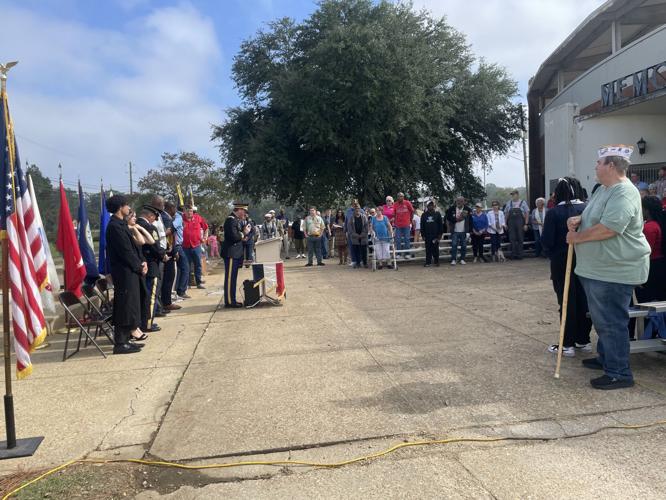 The crowd stands for a closing prayer