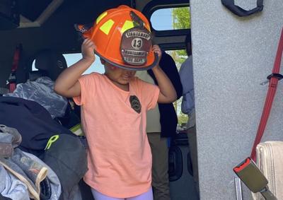 Kid with fire helmet from MFD
