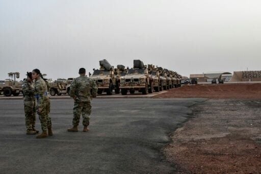 American soldiers prepare to board a cargo plane in Niamey on June 7, 2024 as US forces leave Niger