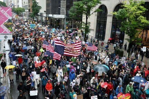 Trump flexes military might at parade as protests sweep US