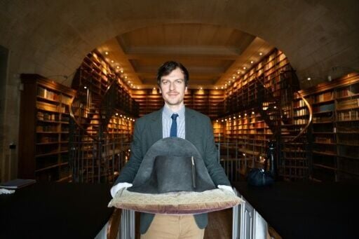 The director of Musee Conde, Mathieu Deldicque, poses with a hat believed to have belonged to Napoleon Bonaparte