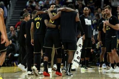 Jimmy Butler is helped off the court by Golden State team-mates after suffering a season-ending knee injury