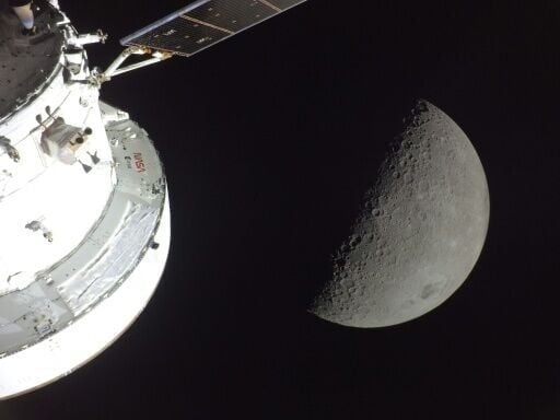 This handout picture released by NASA on April 7, 2026, shows the Orion spacecraft (L) and the Moon (R) on April 6, 2026