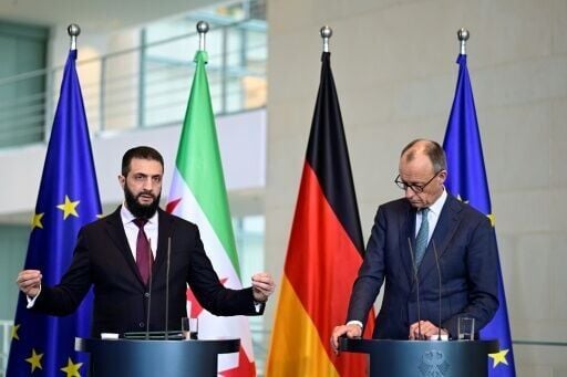 German Chancellor Friedrich Merz (R) and Syrian President Ahmed al-Sharaa address a joint press conference
