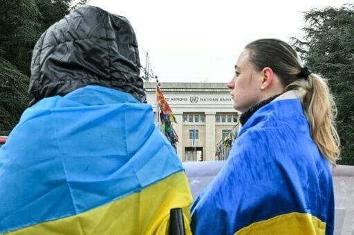 Protesters wearing Ukrainian flags demonstrate outside the United Nations