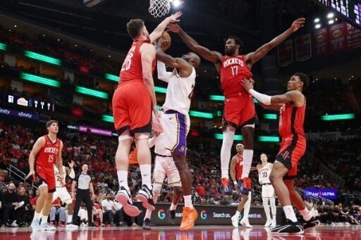 Houston's Alperen Sengun and Tari Eason blocks a shot from LeBron James in the Rockets' NBA playoff victory over the Los Angeles Lakers