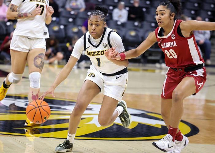 Mizzou guard Shannon Dowell (1) dribbles around Alabama guard Diana Collins
