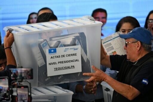 A box with electoral material is carried during the presidential vote count in Tegucigalpa, Honduras, where two right-wing candidates are neck and neck in the vote count