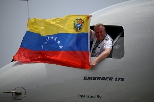 The pilot of an American Airlines flight operated by American Eagle celebrates landing in Caracas as the first direct commercial flight between the United States and Venezuela in seven years