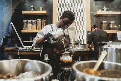 A barista prepares drinks at Qahwah House in Dearborn, Mich.