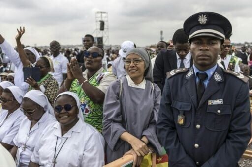 Faithfuls listen as Pope Leo XIV leads a mass at Yaounde airport