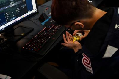 A Taiwanese gamer from the esports team Flash Wolves takes pills during a training session for the 'League of Legends' World Championship at a boot camp in Shanghai.