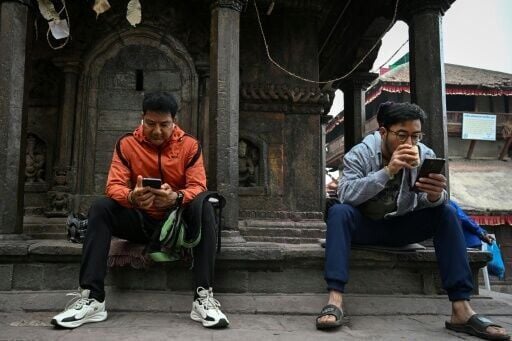 In Kathmandu's tea shops and city squares, people were glued to their phones, checking results as early trends flashed up