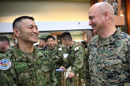 Major General Toshikatu Musha (L) of Japan's Self-Defense Forces, talks to a US Marines officer at the opening ceremony of the annual Balikatan joint military exercise. It is Japan's first year as a full participant