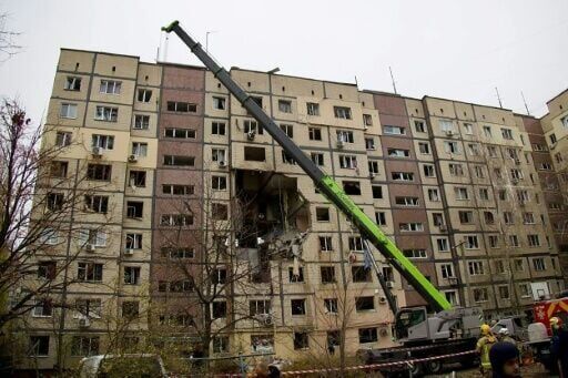 Ukrainian rescuers work at the site of a heavily damaged residential building following an air attack in Dnipro