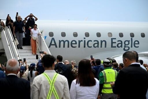Passengers including US and Venezuelan officials disembark in Caracas as the two countries pursue a warming of relations