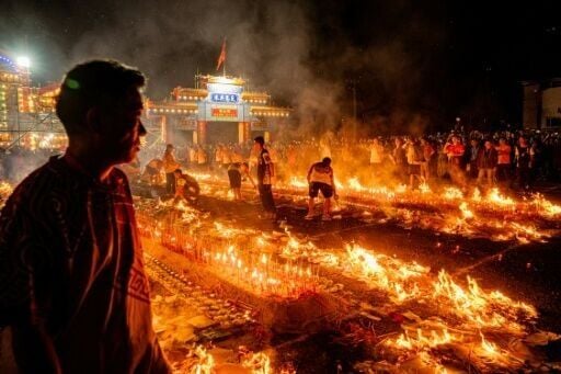 People burn incense sticks while offering prayers during the decennial Jiao Festival of Kam Tin