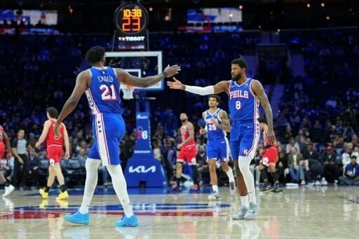 Philadelphia 76ers teammates Joel Embiid and Paul George celebrate a play in the team's NBA victory over the Chicago Bulls