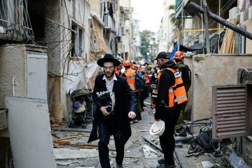 Residents and first responders at the scene following an Iranian strike in Bnei Brak in central Israel on Wednesday