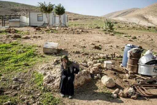 A woman cries as her family pack their belongings and leave home