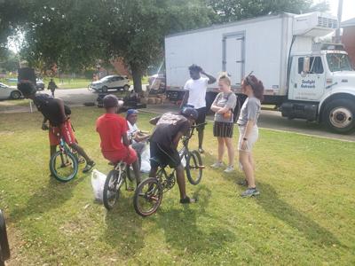 Visitors from Denver representing SCORE receive as much as they give during day of service at GWC Homes