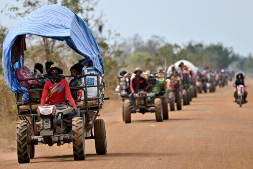 Displaced residents evacuate with their belongings along the Cambodia-Thailand border in Cambodia's Siem Reap province