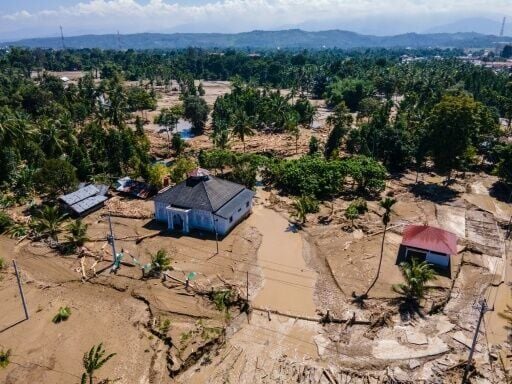 Mud surrounds a mosque in a flood-affected area in Meureudu, in Indonesia's Aceh province