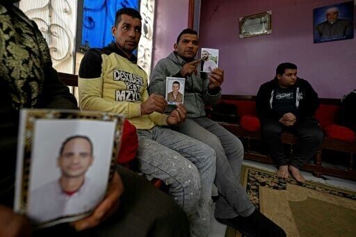 Relatives holding portraits of those believed to to have gone missing while making the journey to Europe through Libya