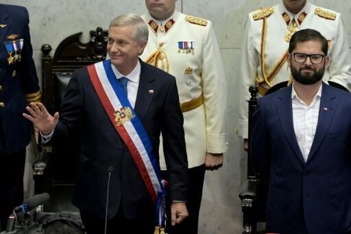 Chilean President Jose Antonio Kast (L) waves at his inauguration as he stands next to outgoing leader Gabriel Boric at the National Congress in Valparaiso