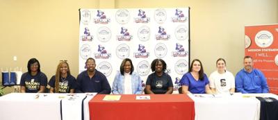 Wallace girl athletes sign scholarships