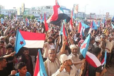 Supporters of the UAE-backed Southern Transitional Council wave flags of South Yemen, which unified with the north in 1990, in the coastal port city of Aden