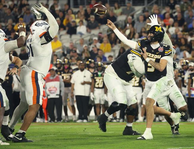 Mizzou quarterback Matt Zollers (5) throws a pass