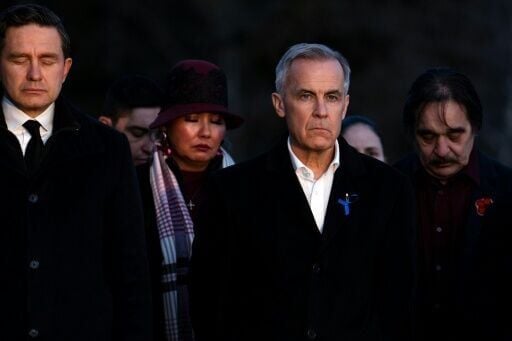 Prime Minister Mark Carney (R) and the leader of the Conservative Party Pierre Poilievre (L) observe a moment of silence to honor the victims of one of Canada’s deadliest shootings