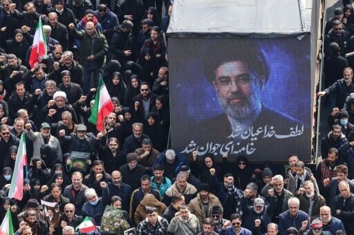 A screen displays a portrait of Iran's new supreme leader Mojtaba Khamenei during the funerals of Iran's Revolutionary Guards Corps (IRGC) commanders, army commanders and others killed in the early days of the United States and Israeli strikes on Iran, ...