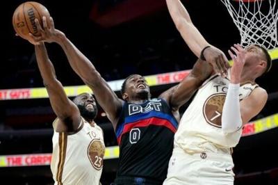 Golden State's Draymond Green blocks a shot attempt by Jalen Duren in the Warriors' NBA loss to the Detroit Pistons