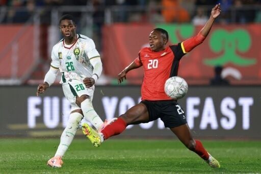 Christian Kofane (L) fires in from outside the box to score Cameroon's second goal against Mozambique in Agadir