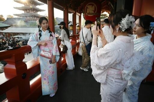 Chinese tourists wear kimonos as they visit the Sensoji Temple in the Asakusa district of Tokyo