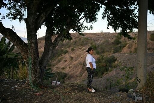 Tomasa Lopez surveys a deep ravine where she suspects a clandestine graveyard of gang victims may be located and which she theorizes could hold the remains of her daughter, who has been missing since 2016