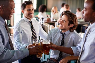 Group Of Businessmen Celebrating With Drinks After Work In Bar