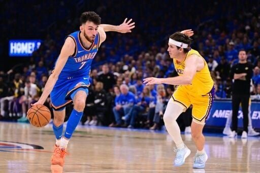 Oklahoma City's Chet Holmgren drives around Austin Reaves in the Thunder's opening playoff win against the Los Angeles Lakers