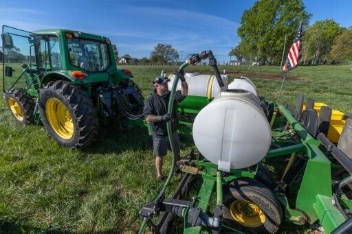 Russell Hedrick, a farmer in North Carolina, prepares a fertilizer blend to be sprayed on his fields as they are being seeded