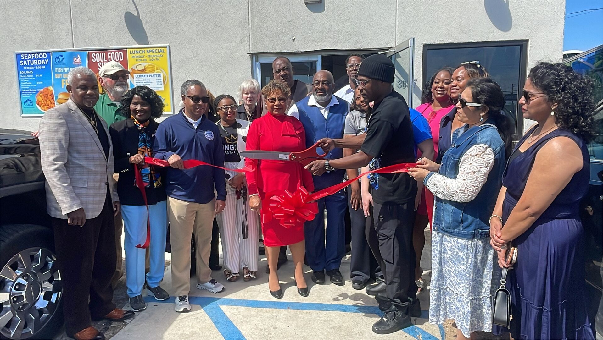 Jamal Jones cuts Clay Seafood ribbon
