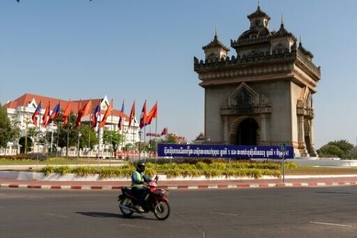 A motorist drives past a banner that translates as "Congratulations to the election of representatives to the 10th National Assembly"