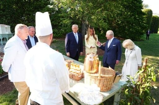 US President Donald Trump and First Lady Melania Trump show Britain's King Charles III and Queen Camilla a display as they tour a beehive on the South Lawn of the White House