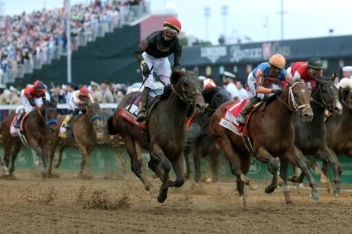 Golden Tempo, ridden by jockey Jose Ortiz, crosses the finish line to win the 152nd running of the Kentucky Derby