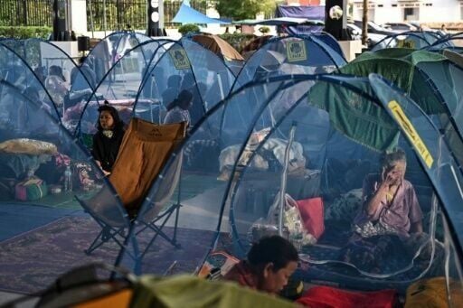 Displaced residents rest as they take shelter at an evacuee center during clashes along the Thai-Cambodia border in Thailand's Sa Kaeo Province