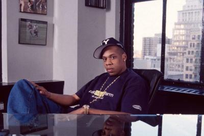 Rapper Jay-Z poses behind his desk in the New York offices of Roc-A-Fella Records in April 1996.