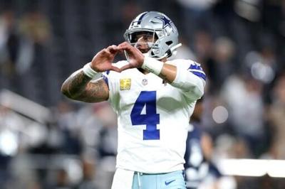 Dallas Cowboys quarterback Dak Prescott makes a heart gesture as the team returned to action for the first time since the death of team-mate Marshawn Kneeland