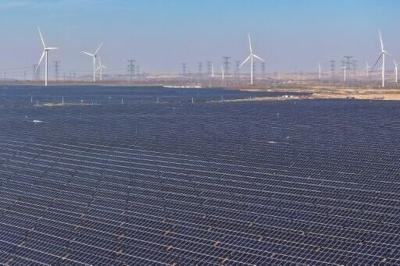 Wind turbines and solar panels -- key to the world's geen energy transition -- are seen at a solar photovoltaic farm in Lingwu in China's northern Ningxia region